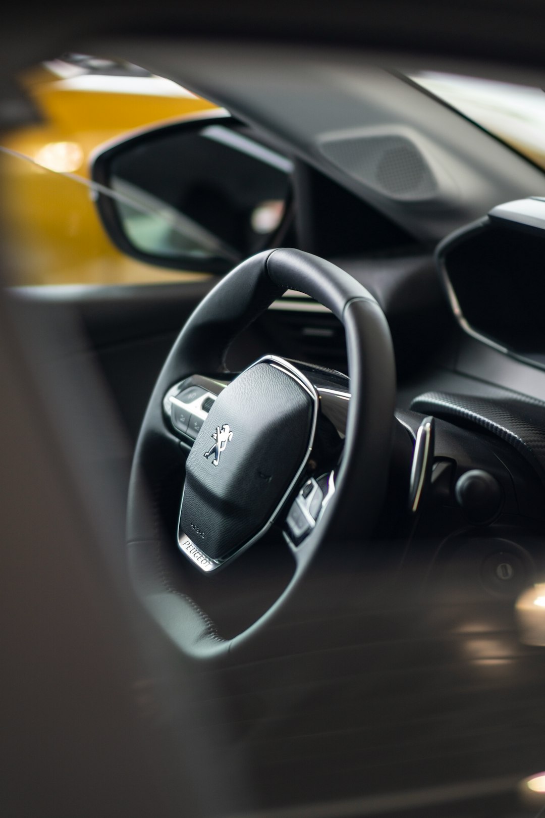 a-close-up-of-a-steering-wheel-and-dashboard-of-a-car-pmfqsqnku-y